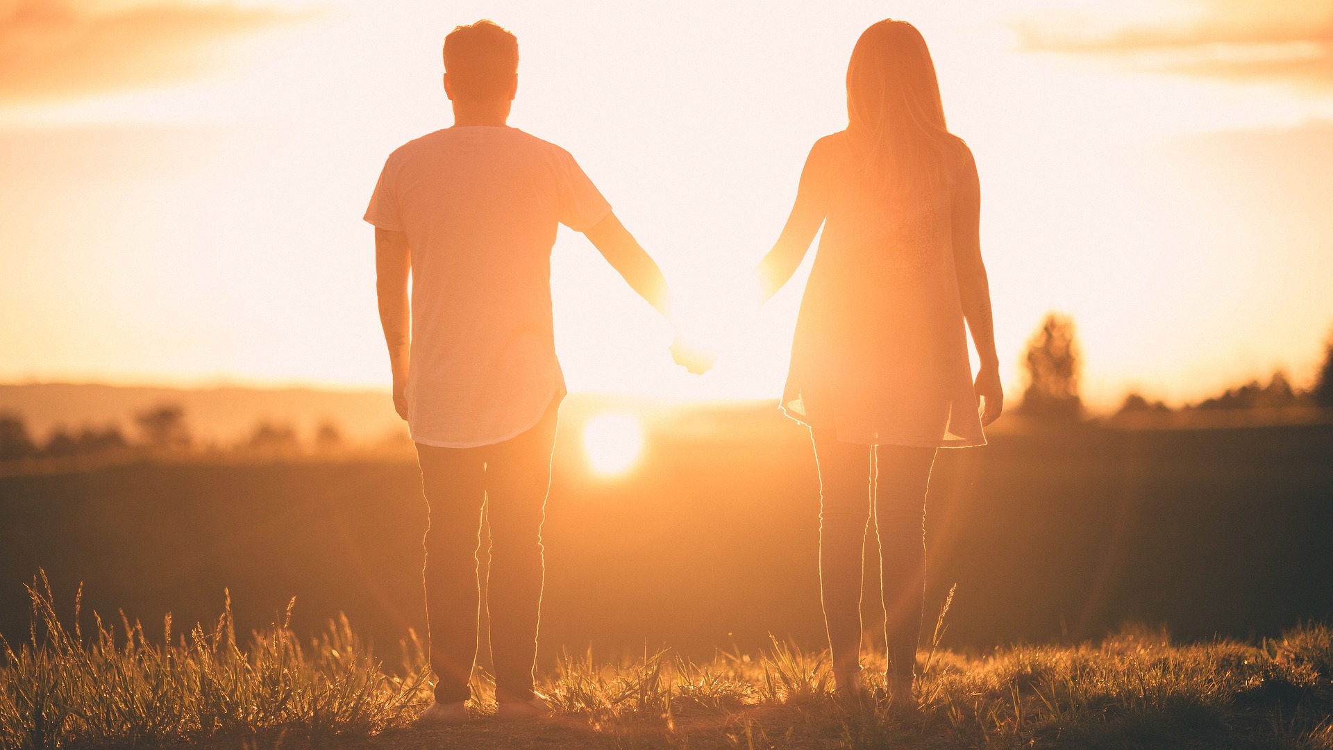 A couple holding hands looking at the sunset | July 31, 2017 | StockSnap | Courtesy of Pixabay