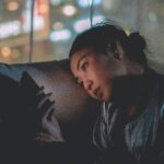 Woman on phone at night in a dark room