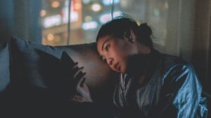 Woman on phone at night in a dark room