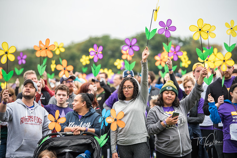 The 2018 Walk to End Alzheimer’s by the Alzheimer’s Association Illinois Chapter. This photograph displays the crowd of people gathered to walk, holding up forget-me-not flowers, which are the symbol of remembrance for those with Alzheimer's.