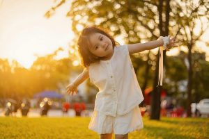 pexels-mochi-mochi-613800453-33285460 Child smiling in a park in Vietnam